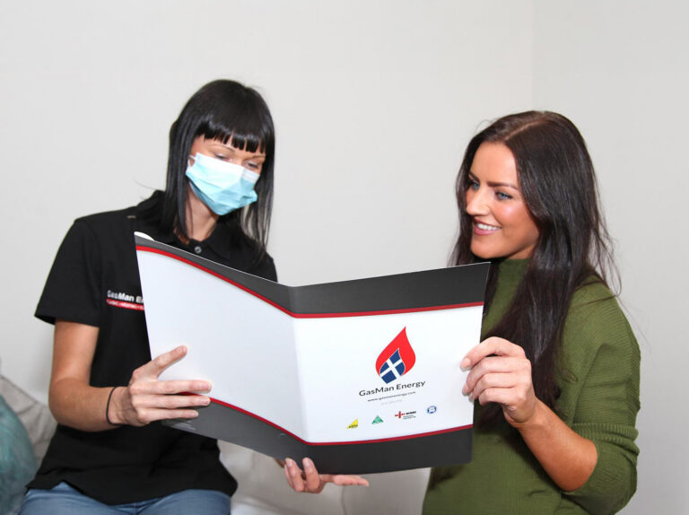 GasMan Energy female engineer wearing a face mask while talking to a customer to protect against Covid-19.